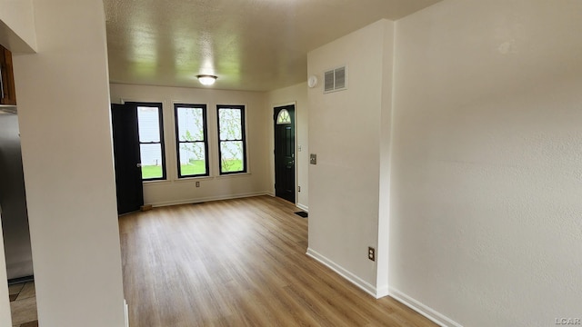 810 Division St, Adrian, MI 49221 - empty room with light wood finished floors and baseboards
