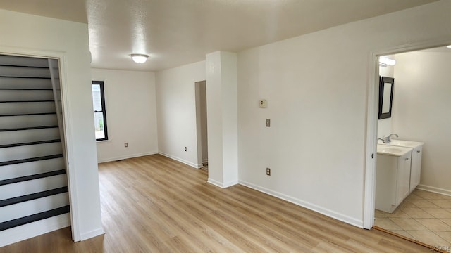 810 Division St, Adrian, MI 49221 - spare room featuring light wood-style flooring and baseboards