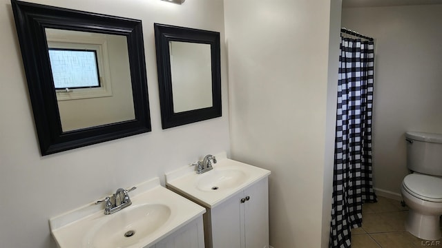 810 Division St, Adrian, MI 49221 - full bath featuring toilet, tile patterned flooring, two vanities, a shower with shower curtain, and baseboards