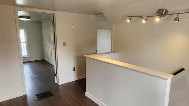 810 Division St, Adrian, MI 49221 - corridor featuring dark wood-style flooring, baseboards, and an upstairs landing