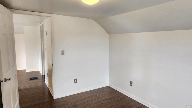 810 Division St, Adrian, MI 49221 - empty room with dark wood-type flooring, baseboards, and lofted ceiling