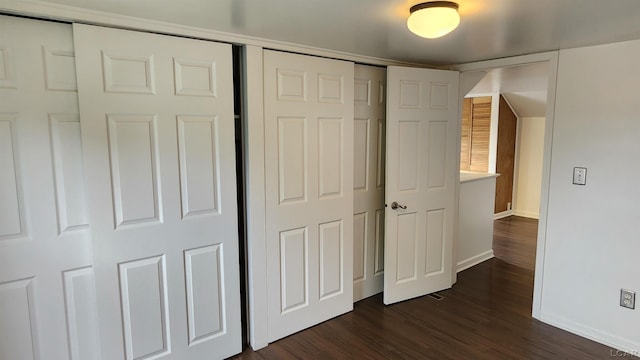 810 Division St, Adrian, MI 49221 - unfurnished bedroom featuring baseboards, dark wood-type flooring, and a closet