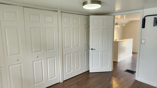 810 Division St, Adrian, MI 49221 - unfurnished bedroom featuring baseboards and dark wood finished floors