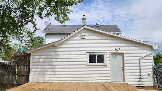 810 Division St, Adrian, MI 49221 - back of house with a deck, a chimney, and roof with shingles