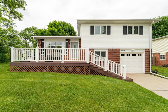 3624 Terhune Rd, Ann Arbor, MI 48104 - back of house with driveway, an attached garage, a yard, brick siding, and a wooden deck