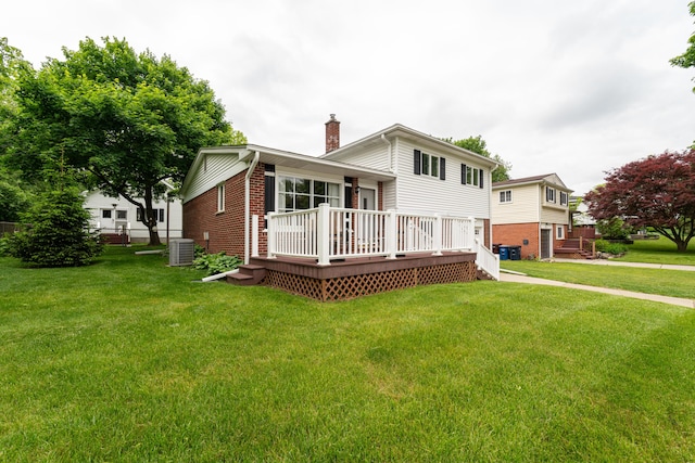 3624 Terhune Rd, Ann Arbor, MI 48104 - back of house featuring a chimney, a wooden deck, brick siding, and a yard