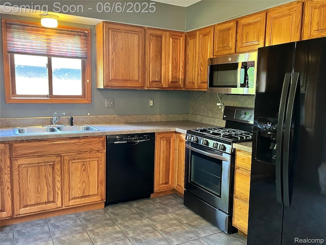 1379 Walter S Hall Dr, Lake Orion, MI 48362 - kitchen with black appliances, a sink, brown cabinets, and light countertops