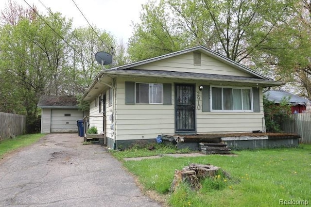 2910 Meisner Ave, Flint, MI 48506 - bungalow-style home with driveway, a detached garage, and an outdoor structure
