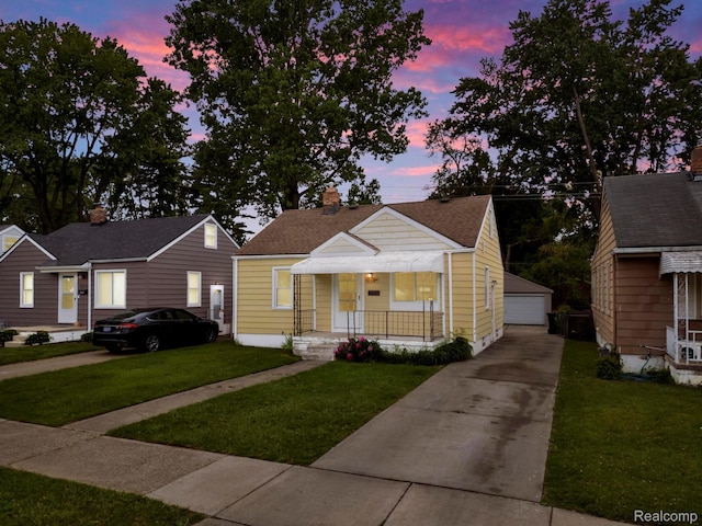 19357 Indian, Redford, MI 48240 - bungalow with an outbuilding, a garage, a lawn, and covered porch