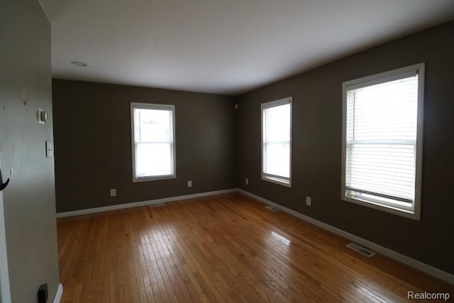 111 N Genesee St, Davison, MI 48423 - unfurnished room with healthy amount of natural light, hardwood / wood-style floors, and baseboards