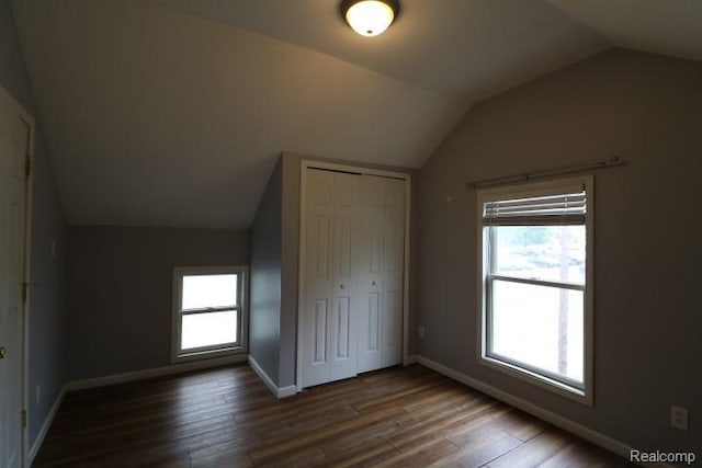 111 N Genesee St, Davison, MI 48423 - unfurnished bedroom featuring vaulted ceiling, wood finished floors, a closet, multiple windows, and baseboards