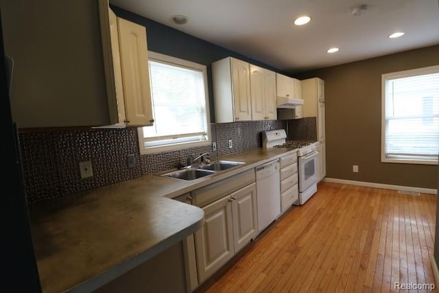 111 N Genesee St, Davison, MI 48423 - kitchen featuring white appliances, a sink, under cabinet range hood, plenty of natural light, and recessed lighting