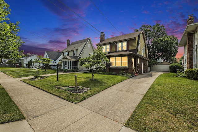 2323 Paris Ave SE, Grand Rapids, MI 49507 - traditional-style house with brick siding, an outdoor structure, a front lawn, and a garage