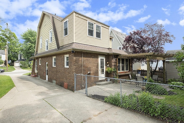 2323 Paris Ave SE, Grand Rapids, MI 49507 - view of side of home with brick siding, a pergola, and roof with shingles