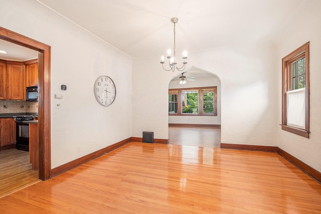 2323 Paris Ave SE, Grand Rapids, MI 49507 - unfurnished dining area featuring a chandelier, light wood-type flooring, and baseboards