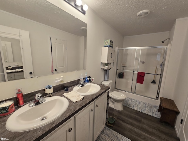 4101 S Sheridan Rd, Lennon, MI 48449 - full bath with a shower with door, wood finished floors, a textured ceiling, and double vanity