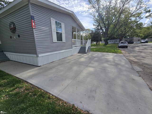 4101 S Sheridan Rd, Lennon, MI 48449 - view of side of home featuring a porch and a lawn