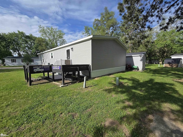 4101 S Sheridan Rd, Lennon, MI 48449 - rear view of house featuring a yard and a storage shed