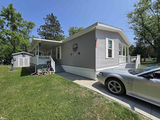 4101 S Sheridan Rd, Lennon, MI 48449 - view of side of home with a yard, a storage shed, and a porch
