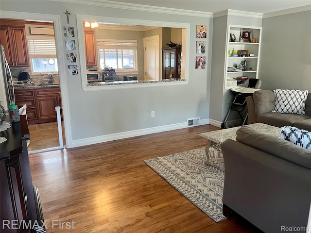 28447 Patricia Ave, Warren, MI 48092 - living room featuring crown molding, wood finished floors, and baseboards
