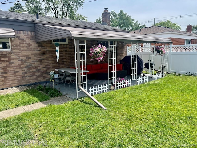 28447 Patricia Ave, Warren, MI 48092 - back of property with brick siding, a patio, and a chimney