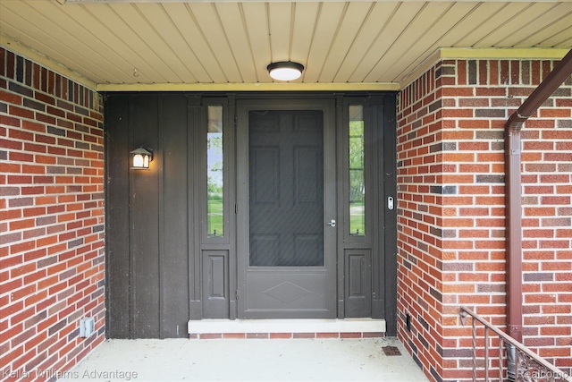 58540 Grand River Ave, New Hudson, MI 48165 - entrance to property featuring brick siding and board and batten siding
