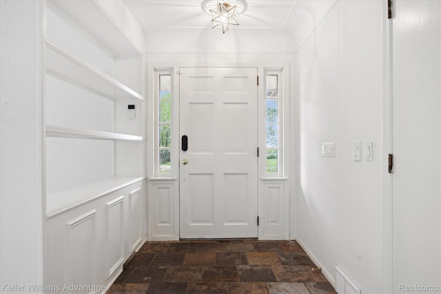 58540 Grand River Ave, New Hudson, MI 48165 - foyer with stone finish flooring, healthy amount of natural light, and baseboards