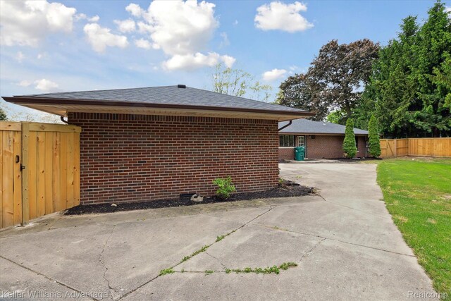 58540 Grand River Ave, New Hudson, MI 48165 - view of home's exterior with brick siding and a shingled roof