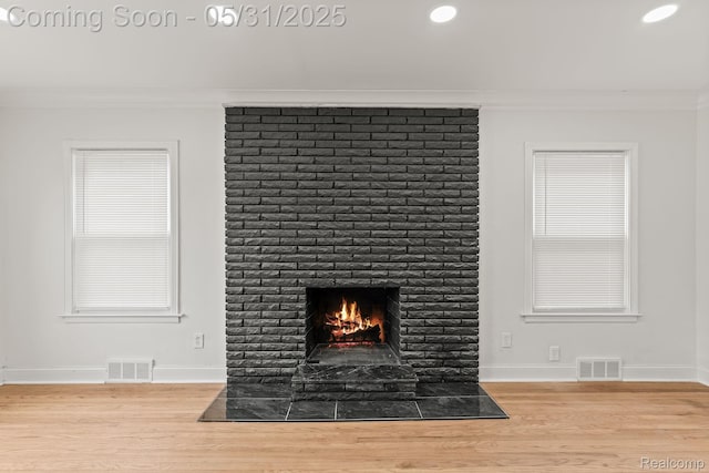 18402 Greenlawn St, Detroit, MI 48221 - detailed view of ornamental molding, a brick fireplace, wood finished floors, baseboards, and recessed lighting