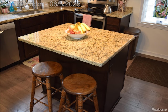 7448 Miller Rd, Swartz Creek, MI 48473 - kitchen with stainless steel range with electric stovetop, dishwashing machine, a sink, baseboards, and dark wood-style flooring