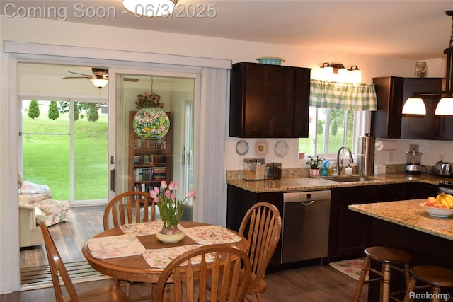 7448 Miller Rd, Swartz Creek, MI 48473 - kitchen featuring stainless steel dishwasher, a sink, dark brown cabinets, dark wood finished floors, and light stone counters