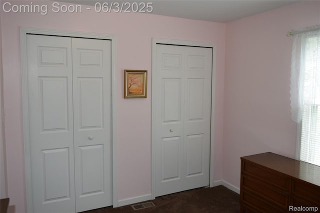 7448 Miller Rd, Swartz Creek, MI 48473 - unfurnished bedroom with dark colored carpet, baseboards, and multiple windows