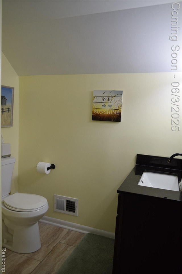 7448 Miller Rd, Swartz Creek, MI 48473 - half bathroom with vanity, toilet, wood finished floors, and baseboards