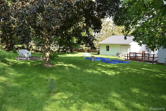 7448 Miller Rd, Swartz Creek, MI 48473 - view of green lawn with a deck