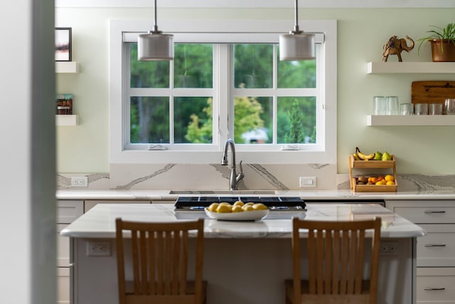 2928 Heeney Rd, Stockbridge, MI 49285 - kitchen featuring healthy amount of natural light, open shelves, light stone countertops, and a sink