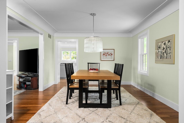 2928 Heeney Rd, Stockbridge, MI 49285 - dining room featuring baseboards, a chandelier, and dark wood-type flooring