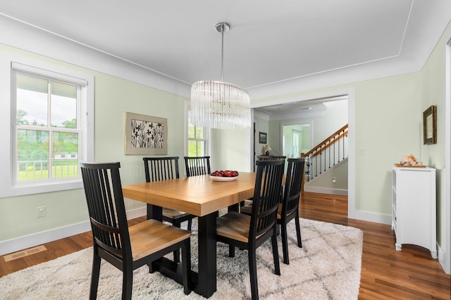2928 Heeney Rd, Stockbridge, MI 49285 - dining area with stairs, baseboards, a chandelier, and wood finished floors