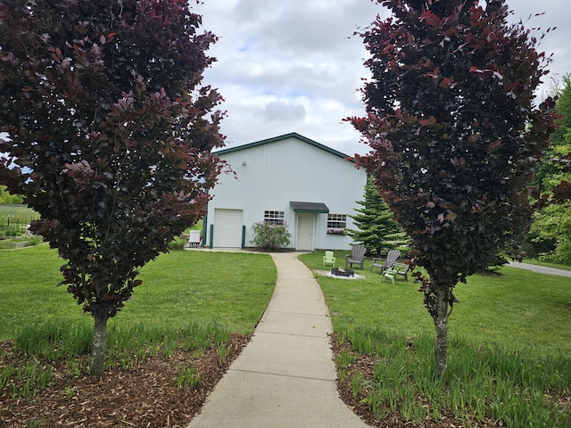 2928 Heeney Rd, Stockbridge, MI 49285 - view of front of house with a front yard and a garage
