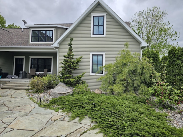 2928 Heeney Rd, Stockbridge, MI 49285 - view of side of property with covered porch and a shingled roof