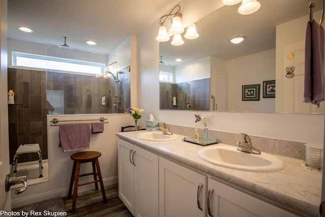 701 Knollcrest Ln, Fremont, MI 49412 - bathroom featuring double vanity and a walk in shower
