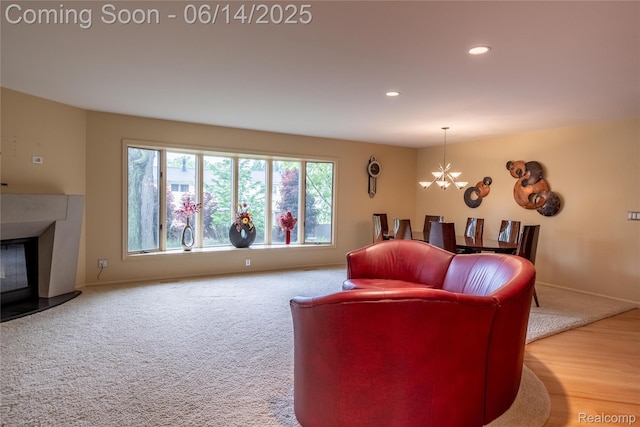 12950 Via Catherina Dr, Grand Blanc, MI 48439 - carpeted living room with a chandelier, a fireplace with raised hearth, and recessed lighting
