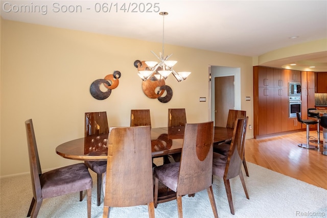 12950 Via Catherina Dr, Grand Blanc, MI 48439 - dining space featuring a chandelier, light carpet, and light wood-style flooring