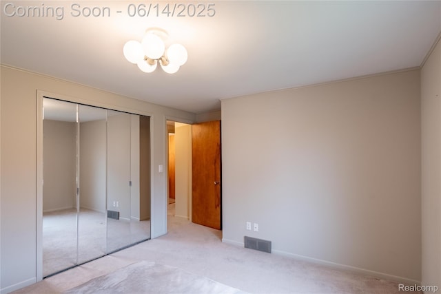 12950 Via Catherina Dr, Grand Blanc, MI 48439 - unfurnished bedroom featuring a closet, a chandelier, and carpet floors