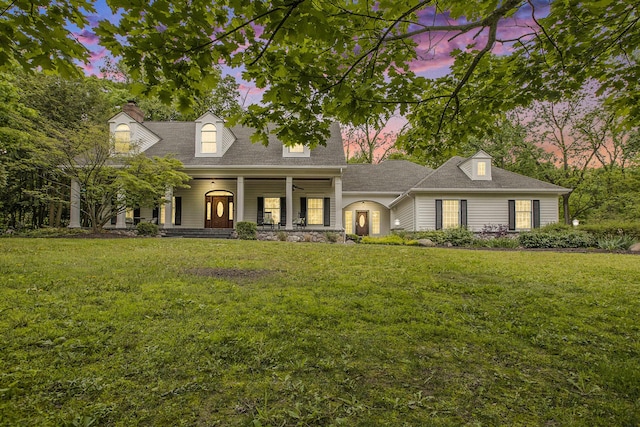 3113 Miller Rd, Ann Arbor, MI 48103 - cape cod home with a front yard, a porch, a shingled roof, and a chimney