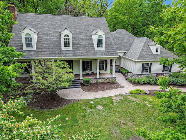 3113 Miller Rd, Ann Arbor, MI 48103 - new england style home with a front yard, a porch, a chimney, and a shingled roof