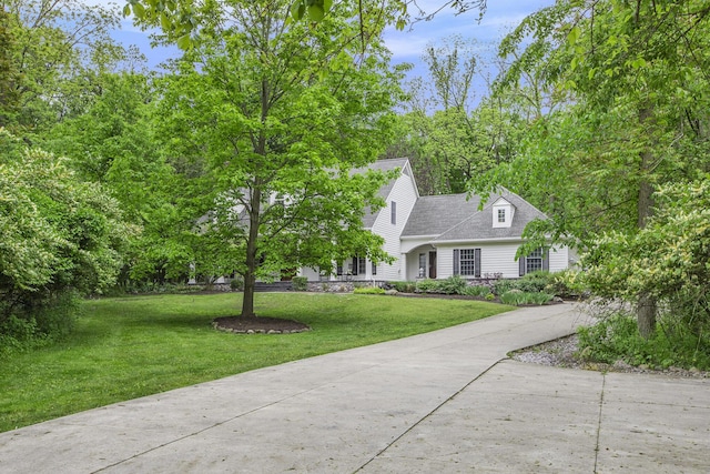 3113 Miller Rd, Ann Arbor, MI 48103 - view of front of house featuring a front lawn, concrete driveway, and roof with shingles