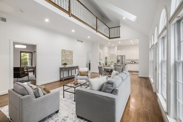 3113 Miller Rd, Ann Arbor, MI 48103 - living area featuring high vaulted ceiling, wood finished floors, recessed lighting, baseboards, and a skylight