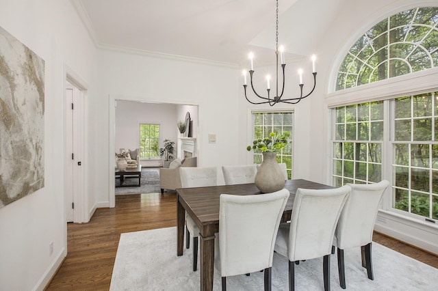 3113 Miller Rd, Ann Arbor, MI 48103 - dining space with a chandelier, dark wood-type flooring, ornamental molding, and baseboards