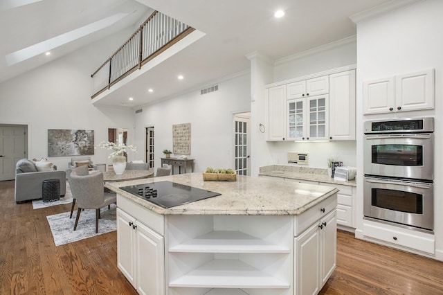 3113 Miller Rd, Ann Arbor, MI 48103 - kitchen with black electric cooktop, double oven, open shelves, a center island, and ornamental molding