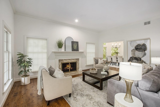 3113 Miller Rd, Ann Arbor, MI 48103 - living room featuring ornamental molding, a chandelier, a high end fireplace, dark wood-type flooring, and baseboards
